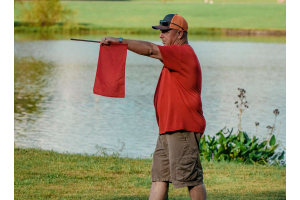 Disc Golf Rules: 5 You Should Learn. Official holding Out of Bonds flag. 