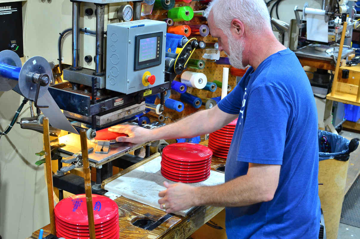 An Innova employee hot stamping discs. Most F2 discs from Innova East are stamp misprints.